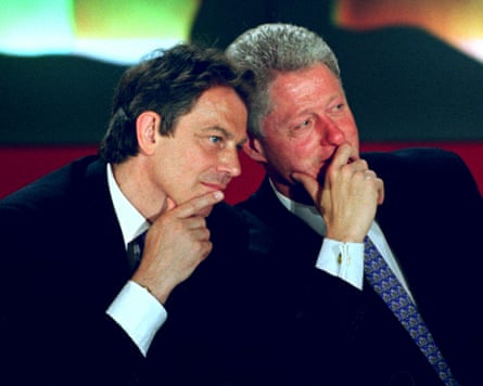 Tony Blair and Bill Clinton with hands on chins and heads leaning together