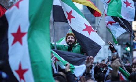 Expatriate Syrians gather with flags in Berlin to celebrate the fall of the Assad regime.