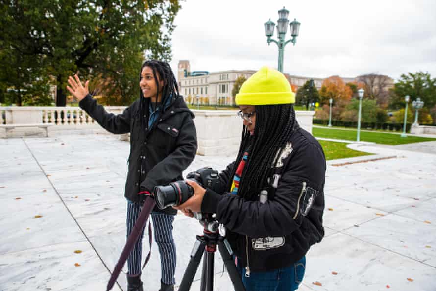 Amber Ford adjust her camera and Amanda King talks to her students as they pose on the steps of the Cleveland Art Museum at Cleveland, Ohio.
