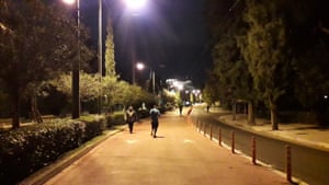 Athenians exercising at night beneath the Acropolis.