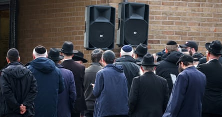 A group of men gather in mourning.