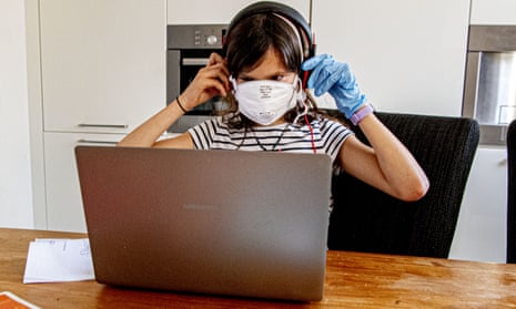 girl in face mask at laptop