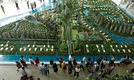 Prospective buyers mill around a development model at the Forest City showroom in Johor Bahru