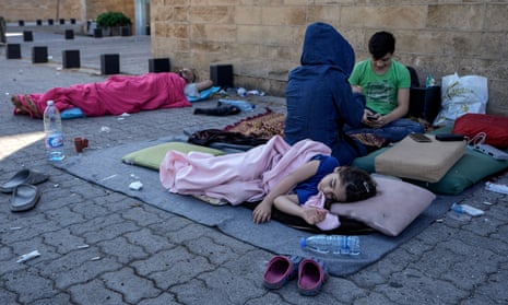 A family sleep on the ground in Beirut after fleeing the Israeli airstrikes in the southern suburbs of Dahiyeh.