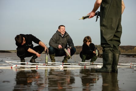Rhun ap Iorwerth joins young people injecting common eelgrass seeds in to the seabed.