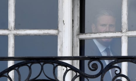 Keir Starmer at the window of his London offices