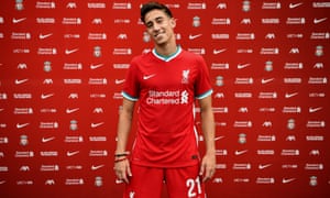Kostas Tsimikas poses in Liverpool’s colours having joined the Premier League champions from Olympiakos on a five-year contract