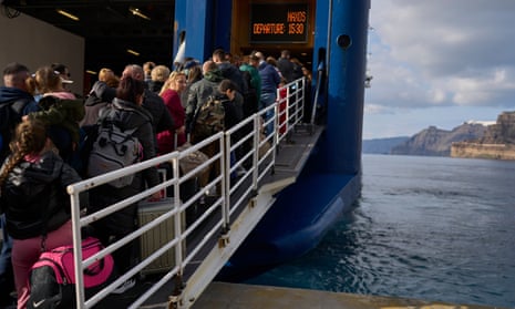 Passengers board a regularly scheduled ferry to Athens’ port of Piraeus, after a spike in seismic activity raised concerns about a potentially powerful earthquake in Santorini, southern Greece, on Monday.