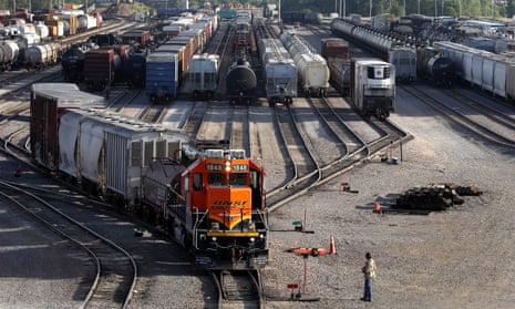 A BNSF rail terminal worker monitors the departure of a freight train on June 2021 in Illinois. 