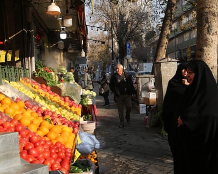 People shop at a fruit and vegetables stall in Tehran