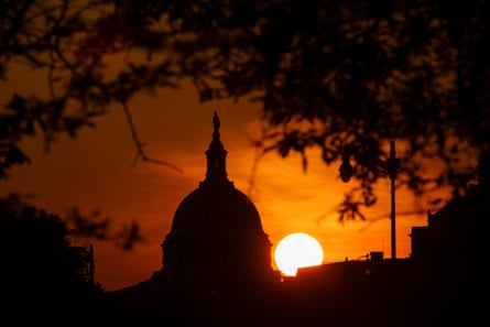 silhouette of building at sunset with orange sky