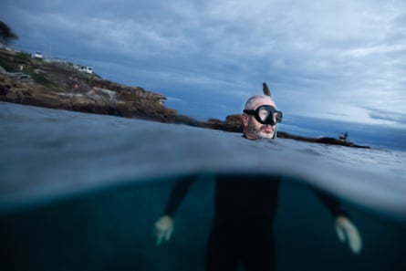 Marine biologist and shark expert Prof Rob Harcourt submerged in a wetsuit at Bondi Beach