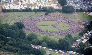 People form a giant peace sign at Glastonbury.