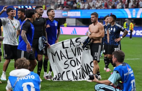 Argentina players hold up a banner with the words ‘Las Malvinas son Argentinas’ following victory in the FIFA World Cup 2026 semi-final