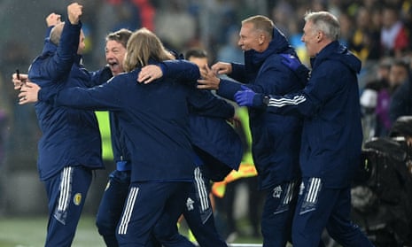 Scotland head coach Steve Clarke is engulfed by his coaching staff after the 0-0 draw with Ukraine in Krakow saw them win their Nations League group