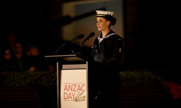 A servicewoman gives a pre-dawn reading before the dawn service at the Australian War Memorial this morning.