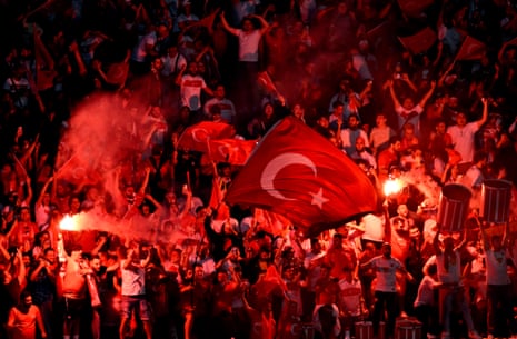 Turkey fans celebrate and let off flares in the stands after Samet Akaydin scores their first goal against Netherlands.