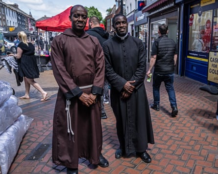 Paschal Uche and Tochukwu Okonkwo stand side by side on a busy shopping street in Grays