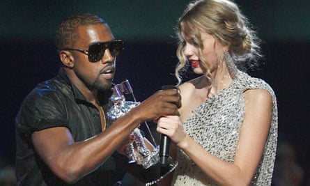 Kanye West takes the microphone from Taylor Swift as she accepts her award during the MTV VMAs in 2009.