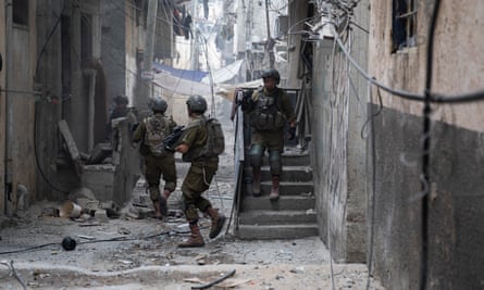 Israeli soldiers carry out a military operation in the Zeitoun district of the southern part of Gaza City on Monday.