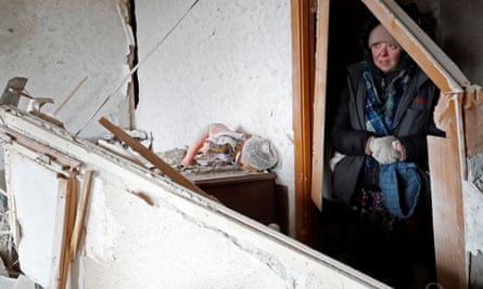 A resident stands inside a damaged apartment in Mariupol.