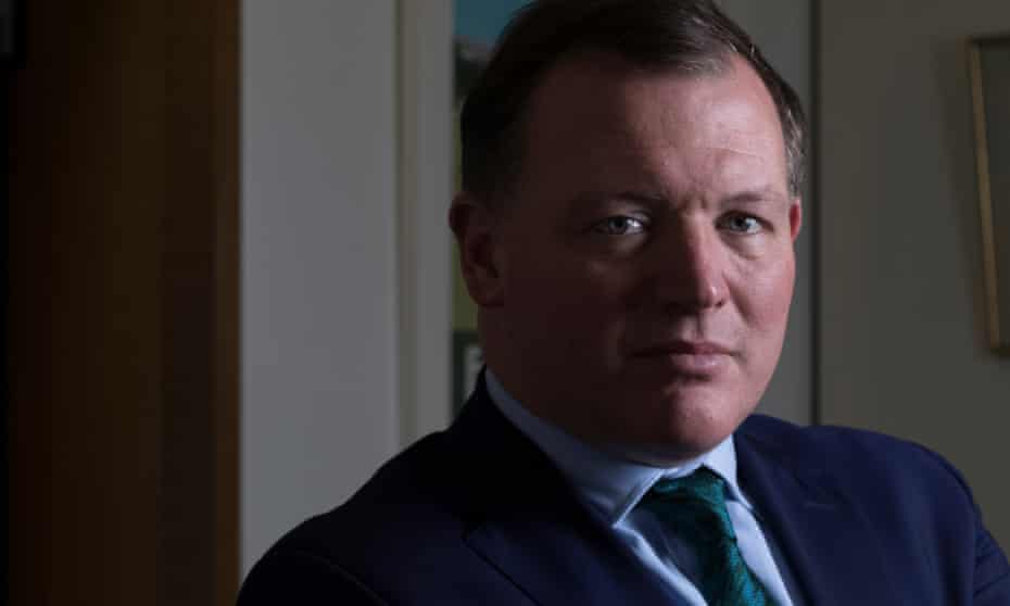 portrait of Tory mp Damian Collins in his office