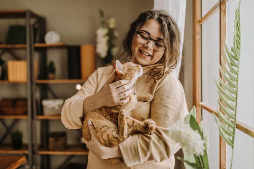 A woman cuddling a cat