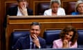 Pedro Sánchez and first deputy PM María smiling in parliament