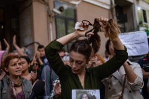 Nasibe Samsaei, an Iranian woman living in Turkey, cuts off her ponytail during a protest outside the Iranian consulate in Istanbul following the death of an Iranian woman after her arrest by the country’s morality police in Tehran