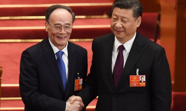 Wang Qishan, left, shakes hands with Xi Jinping after being elected vice president.