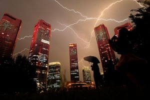 People watch a light show  on buildings in Beijing