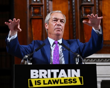 He stands with arms outstretched at a lectern with a slogan that reads Britain is Lawless