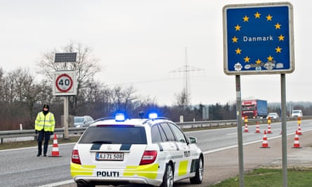 Danish police officers check vehicles at the border with Germany.