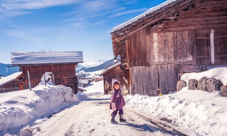 Baby girl enjoying snow in Le Grand-Bornand French alps ski resort.