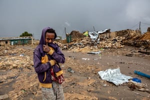 A boy stadsn amid rubble after Togoga (or Togogwa) was hit on June 22 by an Ethiopian airstrike