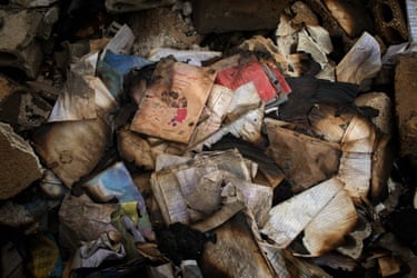 Hundreds of charred textbooks in a pile