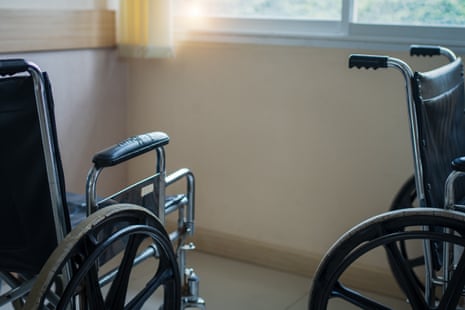 Empty wheelchair parked in hospital.