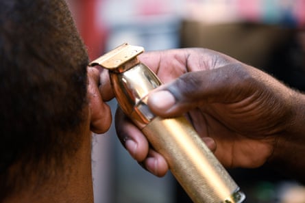 Julian Turner, 36, receives a haircut at Daddy’s Choice Barber Shop. Shop owner Rev Kenneth B Thomas Sr encourages his clientele to get vaccinated.
