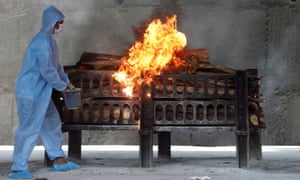 Frontline workers prepare a funeral pyre on the outskirts of Mumbai.