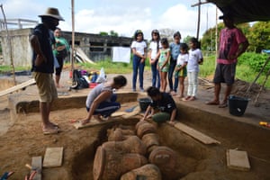 Archaeologist unearth urns buried near from the community school in Tauary, in the Brazilian Amazon.