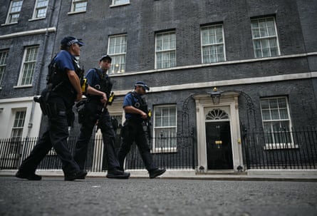 Armed police officers patrol outside 10 Downing Street