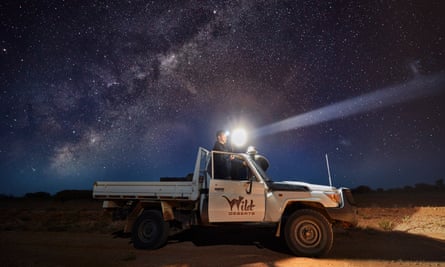 An ecologist documenting kangaroo numbers from his ute at the Wild Deserts research station