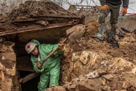 Oleksiy Yukov, the head of Black Tulip, works to extract the Russian corpses from a cellar in Krasnopillia