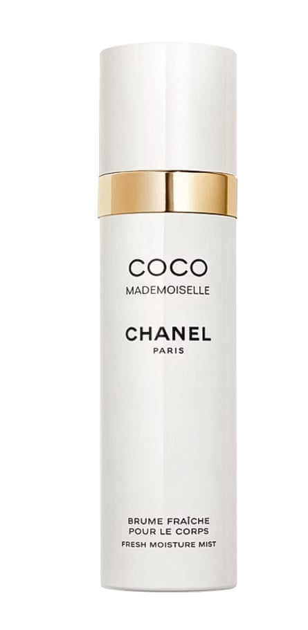 A pearly white and gold bottle with black text of Chanel Coco Mademoiselle body mist
