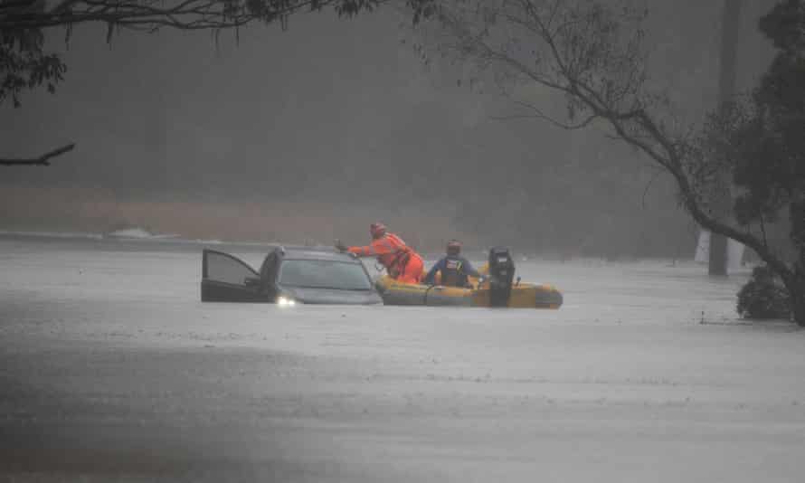An SES swift water rescue boat attends to Brian Russell’s car after rescuing him from his flooded vehicle along Blacktown Road, near Richmond, west of Sydney.