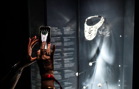 A visitor takes a picture of the platinum and diamond necklace, which dates from 1939 and belonged to Queen Nazli of Egypt, during the Pierres Précieuses exhibition in Paris.