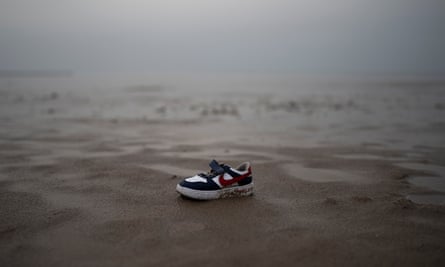 A child’s shoe lies on the sand on a beach in Dunkirk, France