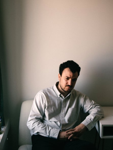 A man sits in his home somberly
