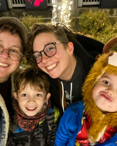 Two adults and two children smiling.