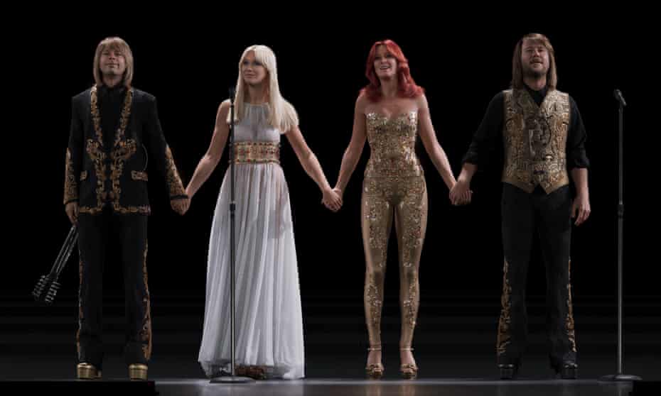 The four digitised Abba members, with Anni-Frid in a strapless sparkly gold catsuit and Agnetha in white Grecian gown